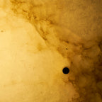 Very close view of the lit alabaster on this Clérachic ceiling light, with golden cloud-like veins and a dark screw hole.