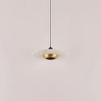 Clérachic Alabaster Disc Pendant Light switched off, showing the stone veining and the polished brass bowl at its centre.