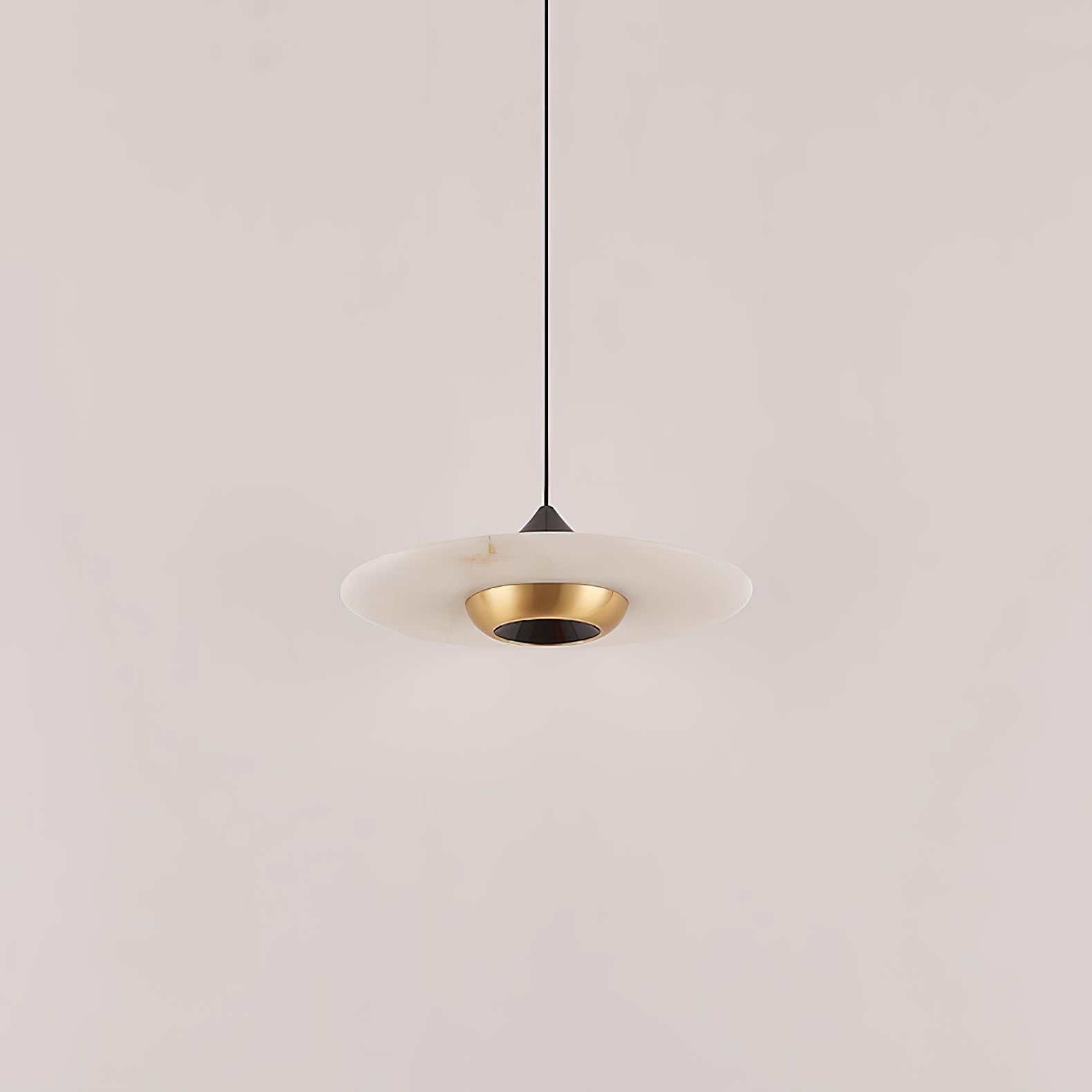 Clérachic Alabaster Disc Pendant Light switched off, showing the stone veining and the polished brass bowl at its centre.