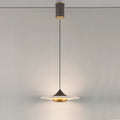 Clérachic Alabaster Disc Pendant Light hung from its cylindrical ceiling canopy, lighting a plain wall from a long drop.