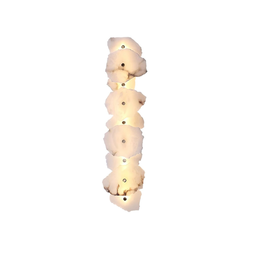 Clérachic's seven-head alabaster lamp stacked vertically on white, each shade glowing softly along its length.