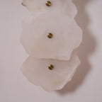 Clérachic's alabaster shades in close-up, unlit, revealing the brushed brass mounting caps at each centre.