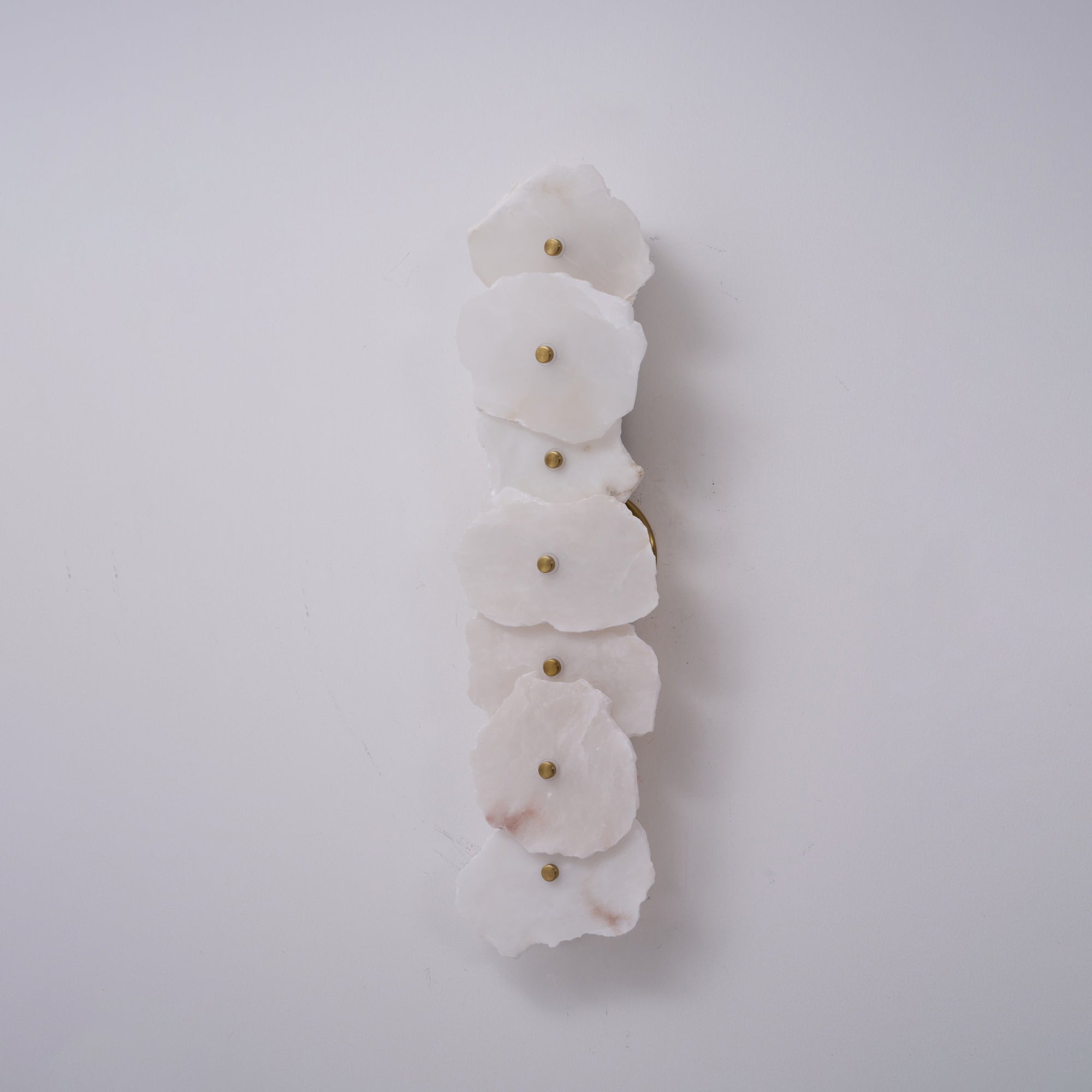 The Clérachic six-head alabaster lamp shown unlit on white, highlighting the natural stone's shape and texture.