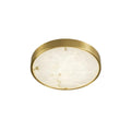 Round Clérachic alabaster flush ceiling light photographed from a low angle, showing how little the shallow brass body projects.