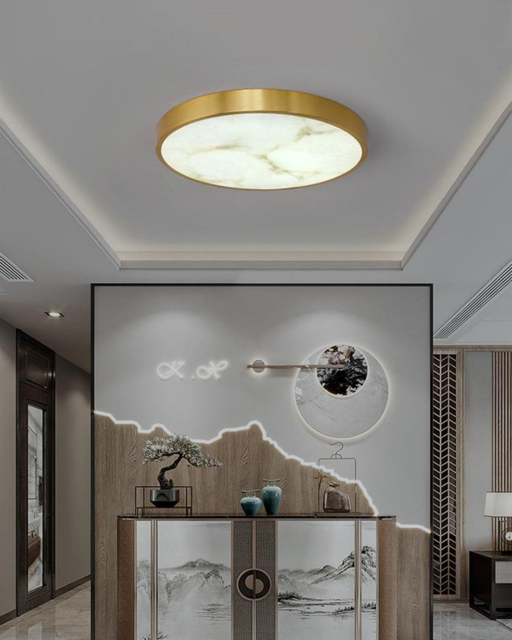 Clérachic alabaster flush ceiling light in round form, lighting an entry hall above a console with a bonsai and vases.