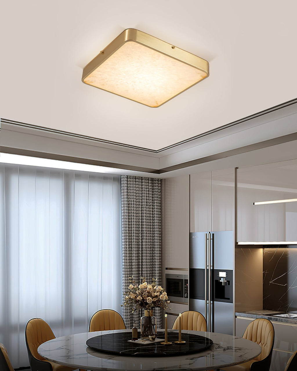 Square Clérachic alabaster flush ceiling light above a round marble dining table, with the kitchen visible beyond.
