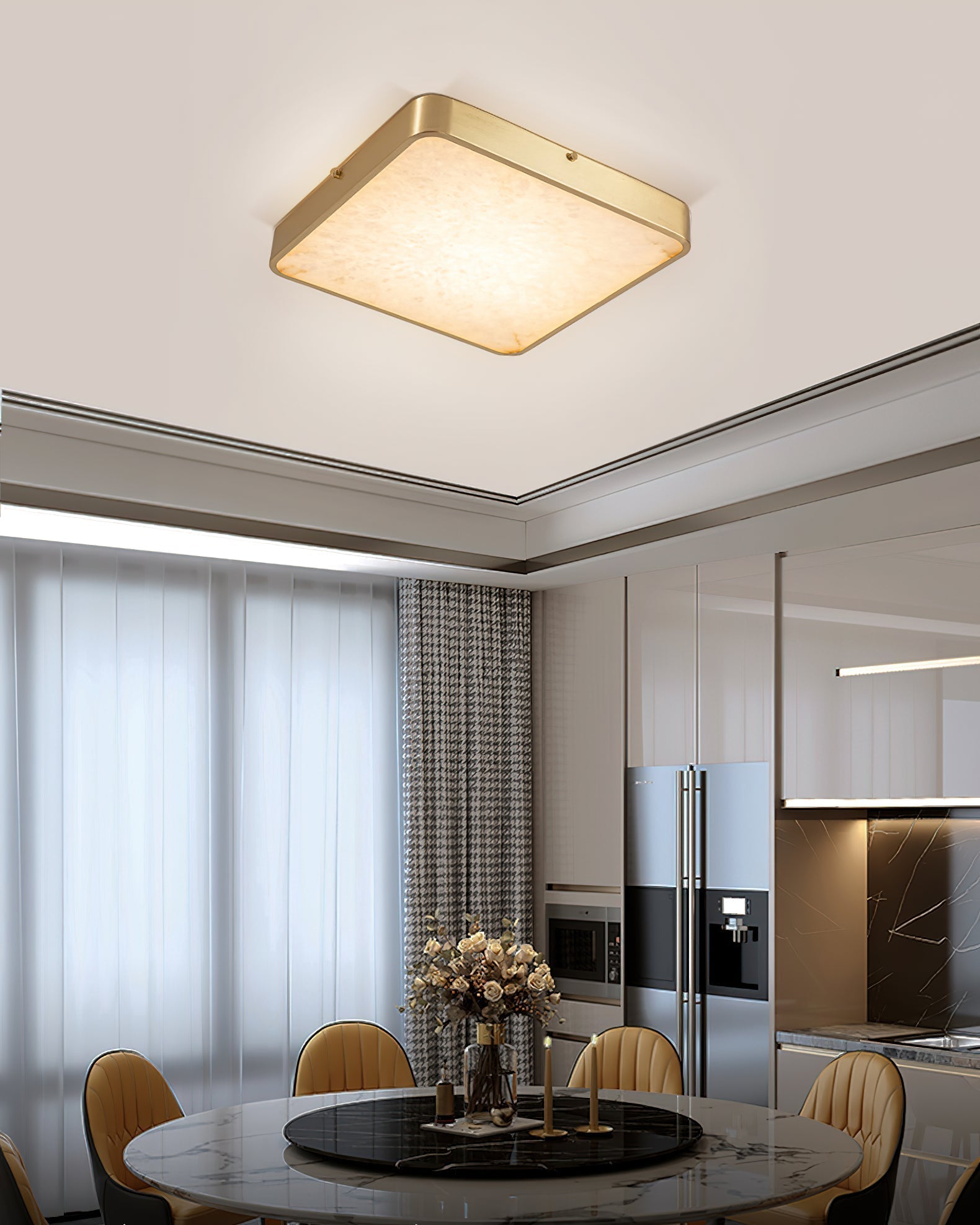 Square Clérachic alabaster flush ceiling light above a round marble dining table, with the kitchen visible beyond.