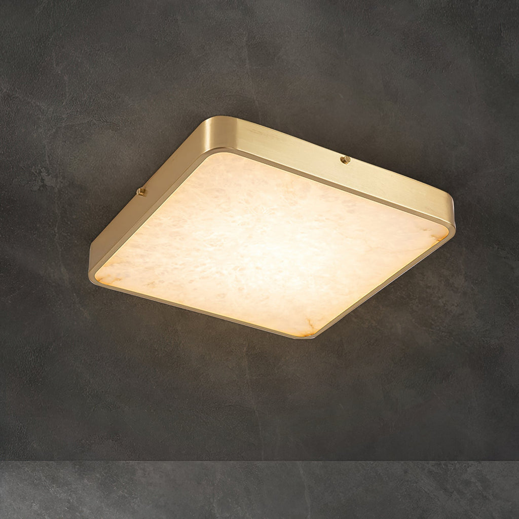 Square Clérachic alabaster flush ceiling light glowing warm against a dark concrete ceiling, brass band lit along its edges.