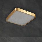 Unlit square Clérachic alabaster flush ceiling light on dark concrete, the stone face pale and the brass band matte.