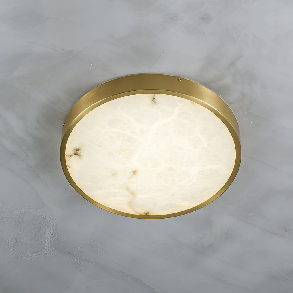 Round Clérachic alabaster flush ceiling light lit on a marble ceiling, the stone glowing from the LED behind it.