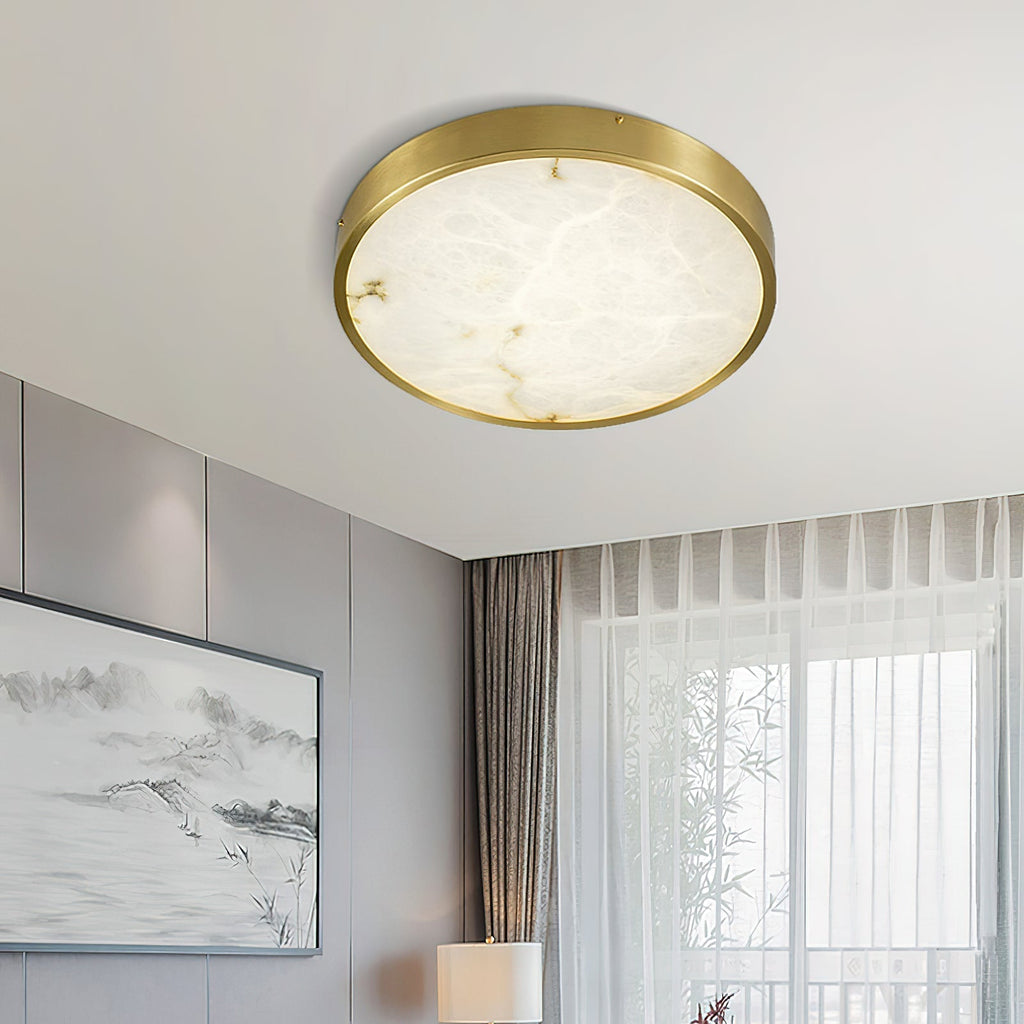 Clérachic alabaster flush ceiling light, round, lighting a corner of a panelled room with artwork and sheer curtains.