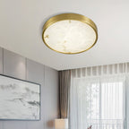 Clérachic alabaster flush ceiling light, round, lighting a corner of a panelled room with artwork and sheer curtains.