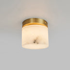 Angled view of the Clérachic alabaster cylinder ceiling light showing the domed underside and the slim brushed brass mounting ring