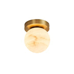 Clérachic alabaster flush mount ceiling light shown on white, the globe shade veined amber beneath a deep brushed brass canopy