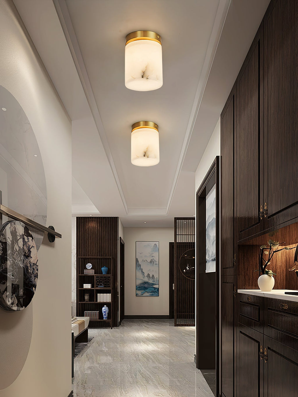 Two Clérachic alabaster cylinder ceiling lights lighting an entry corridor with dark cabinetry and a polished marble floor