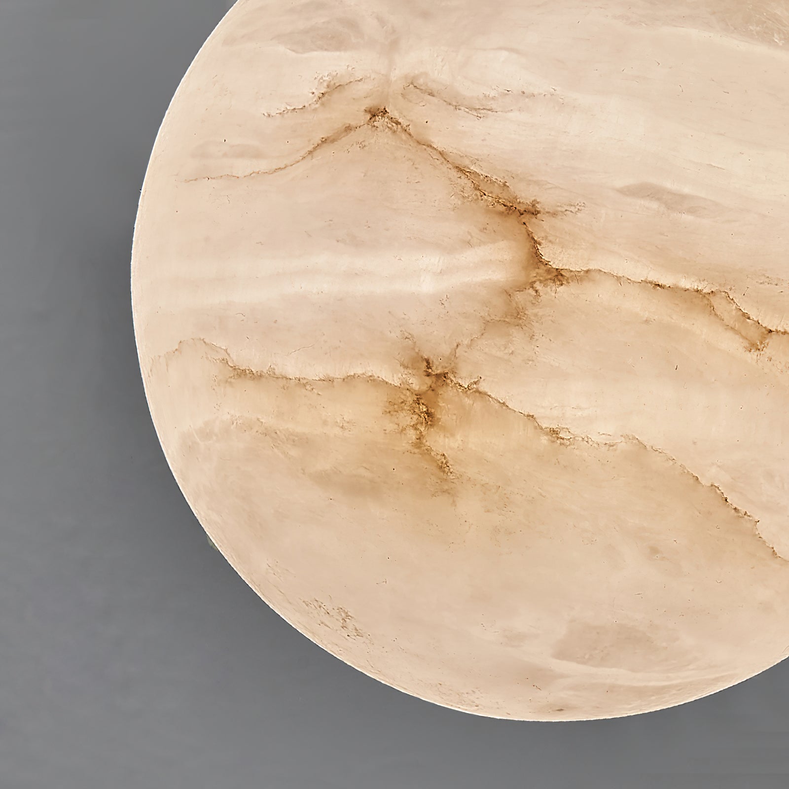 Macro detail of the Clérachic alabaster shade, natural stone veining and translucent grain filling the frame