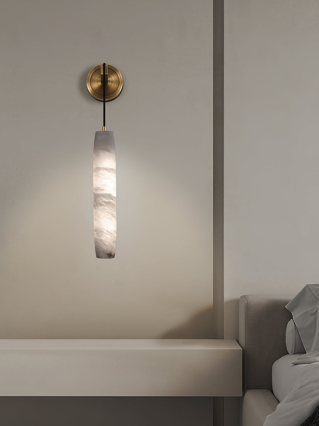 The Clérachic sconce above a floating stone ledge, casting a soft pool of light down the plaster wall.