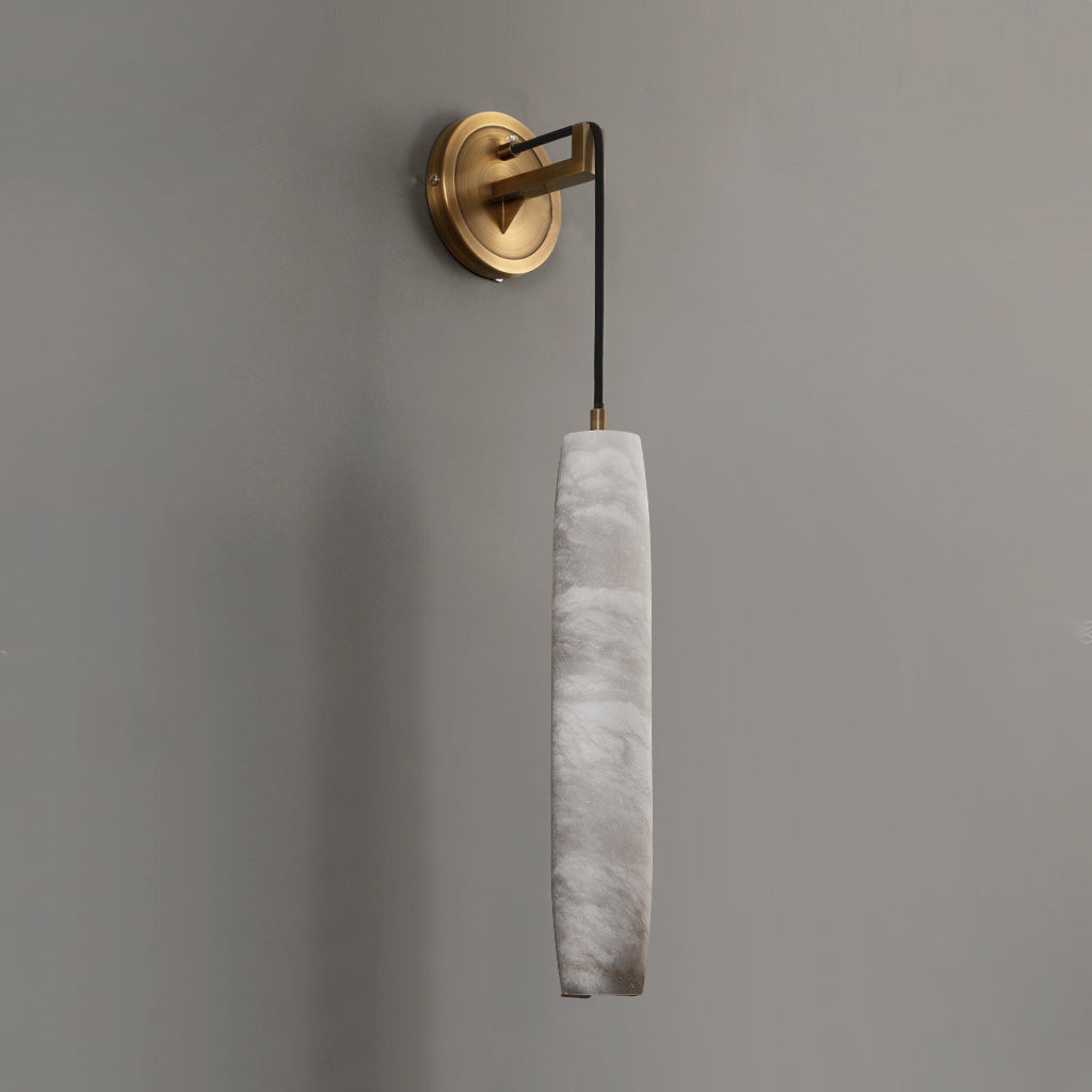 The Clérachic alabaster shade unlit on a warm grey wall, showing its milky veining and hand-finished edges.