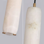 The Clérachic shade in close-up: brass cradle under the alabaster tube, and the brass collar at the cord entry.