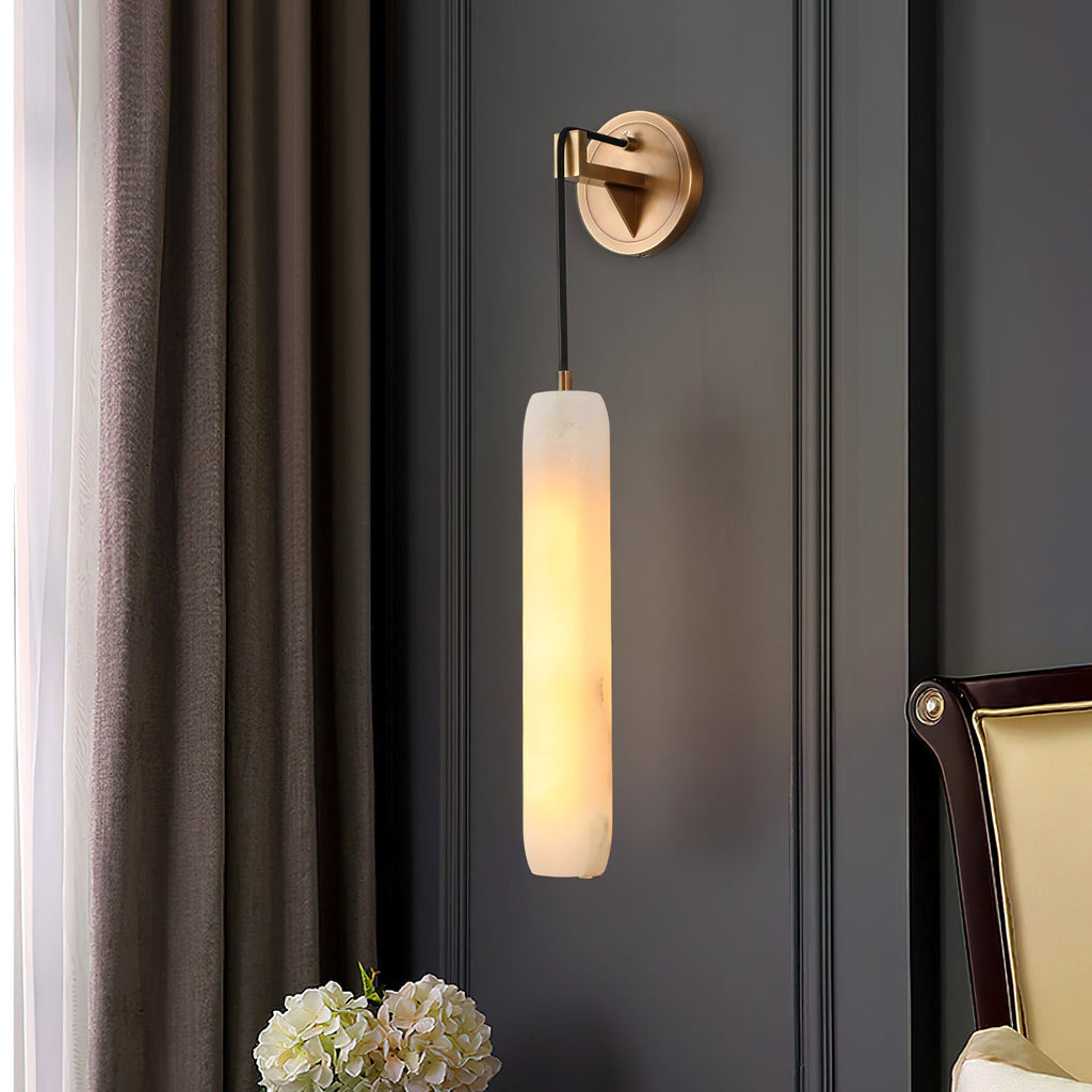 Clérachic sconce against dark grey panelling, framed by a linen curtain and a vase of white hydrangeas.