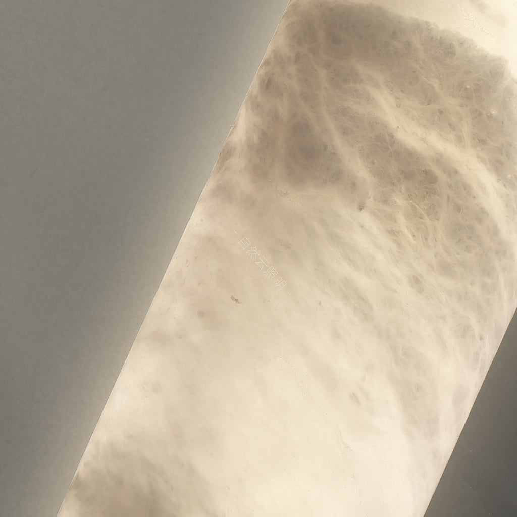 Macro of the Clérachic alabaster shade, backlight picking out cloudy grey veining right across the stone.