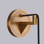 The Clérachic brass wall plate in close-up, its triangular bracket and braided black cord fixed to the canopy.