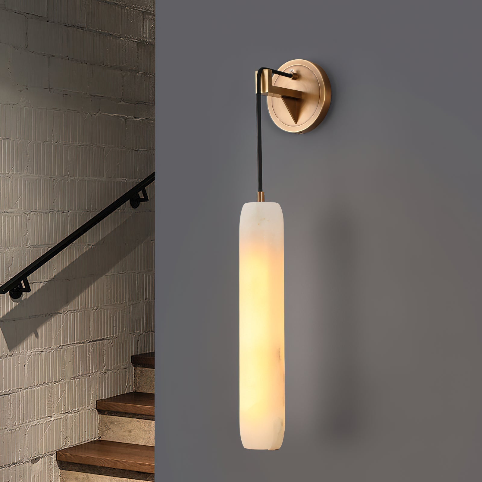 Clérachic sconce lighting a whitewashed brick stairwell, hung level with the black handrail as you climb.