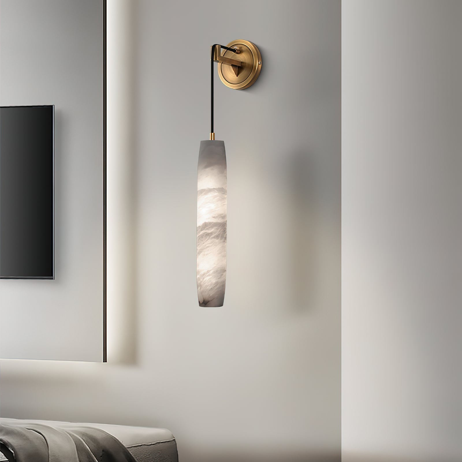 Clérachic sconce on a white bedroom wall next to a mounted screen, the alabaster unlit and softly grey.