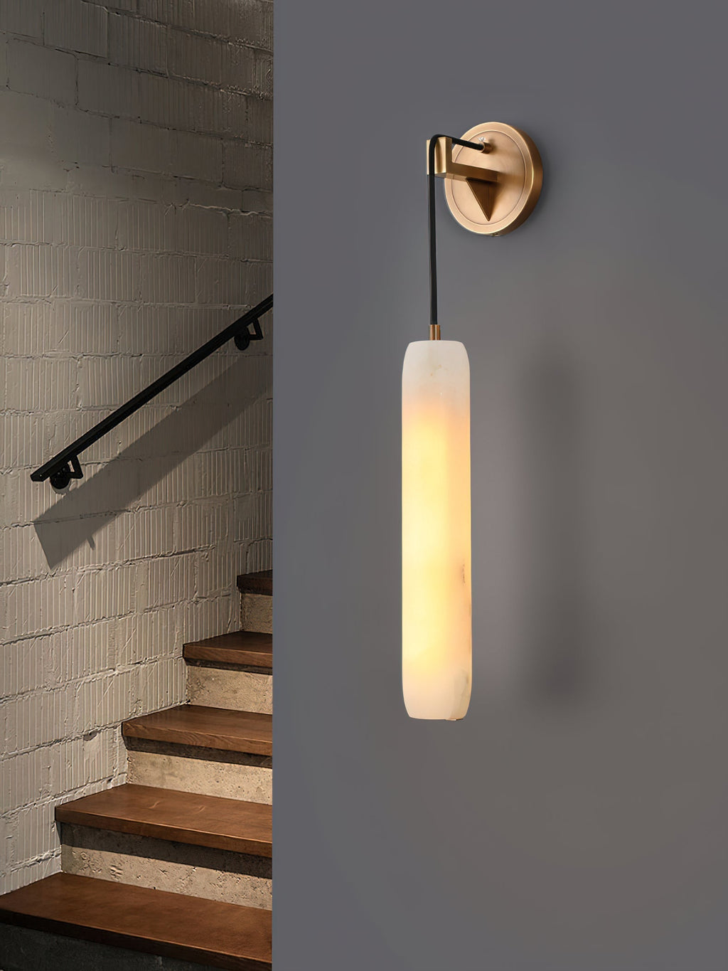 Clérachic sconce shown twice, on brick beside a staircase and on a plain grey wall, to compare settings.