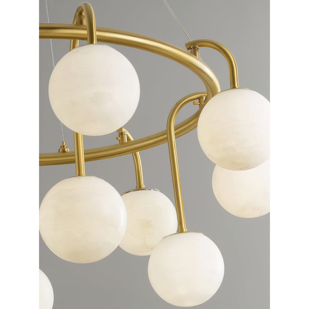 Detail of the Clérachic Alabaster Globe Chandelier ring, with hooked brass arms and short stems setting the globes at two heights.
