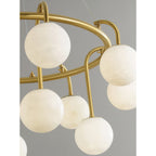 Detail of the Clérachic Alabaster Globe Chandelier ring, with hooked brass arms and short stems setting the globes at two heights.