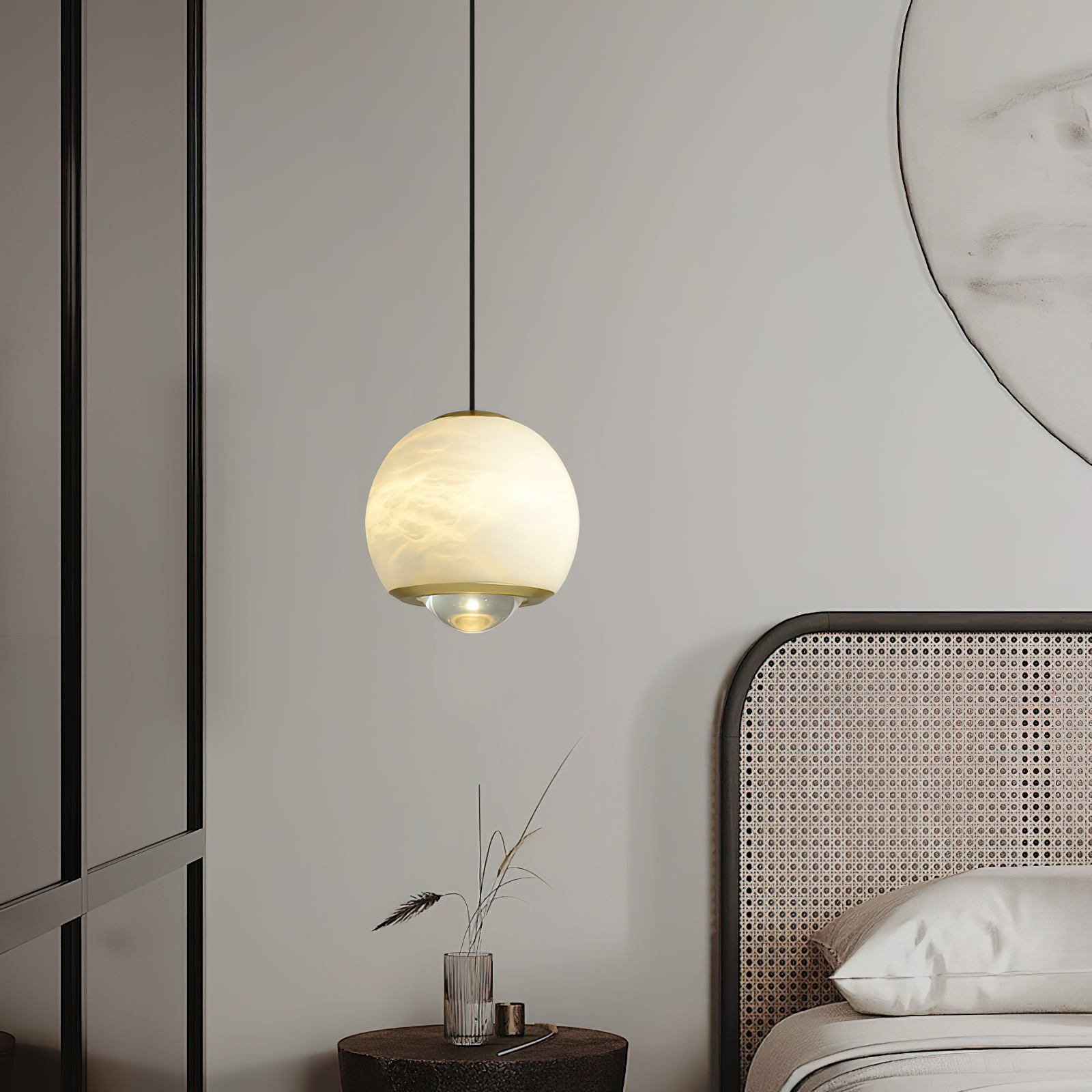 Clérachic Alabaster Globe Pendant Light glowing honey-cream beside a caned bed, its brass band and lens aimed at the side table below.