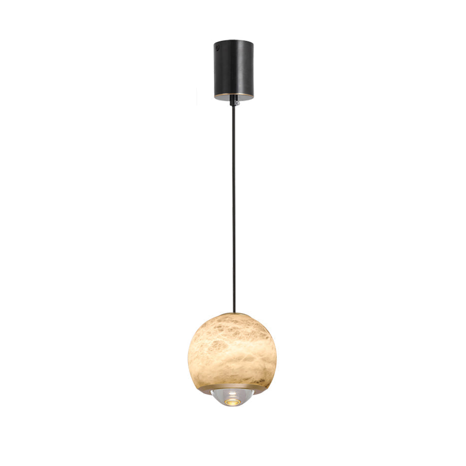 Studio view of the Clérachic Alabaster Globe Pendant Light, a brass band under the stone globe holding the clear stepped lens that beams down.