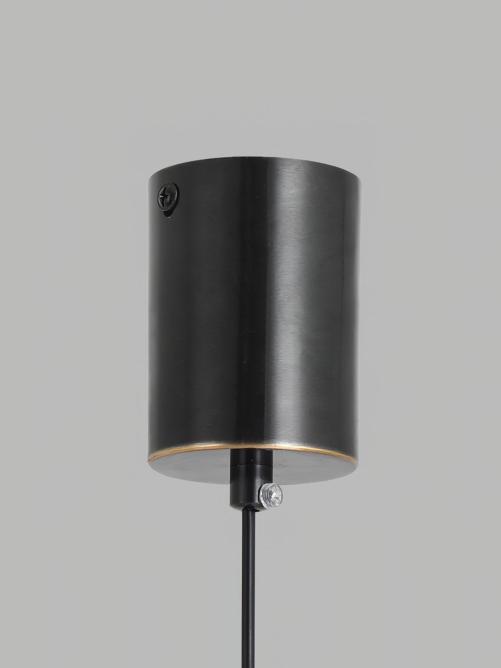 Close-up of the black cylinder canopy on the Clérachic Alabaster Globe Pendant Light, with its fixing screw and cord grip for the ceiling.