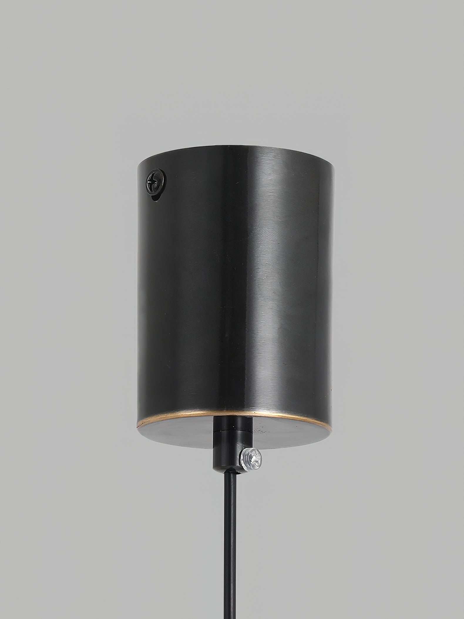 Close-up of the black cylinder canopy on the Clérachic Alabaster Globe Pendant Light, with its fixing screw and cord grip for the ceiling.