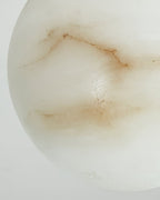 Macro detail of the Clérachic Alabaster Globe Pendant Light, showing the natural seams and pitting that make each globe its own.