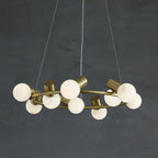 Clérachic Alabaster Globe Ring Chandelier in brass, stone globes set alternately above and below the ring on dark plaster.