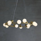 Clérachic Alabaster Globe Ring Chandelier viewed from below, the wide brass ring circled with matte alabaster spheres.