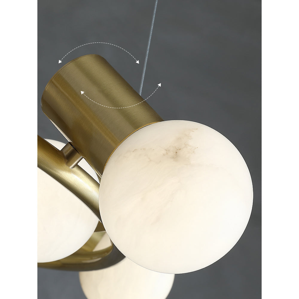 Grey veining runs through one stone globe on the Clérachic Alabaster Globe Ring Chandelier, held in its angled brass socket.