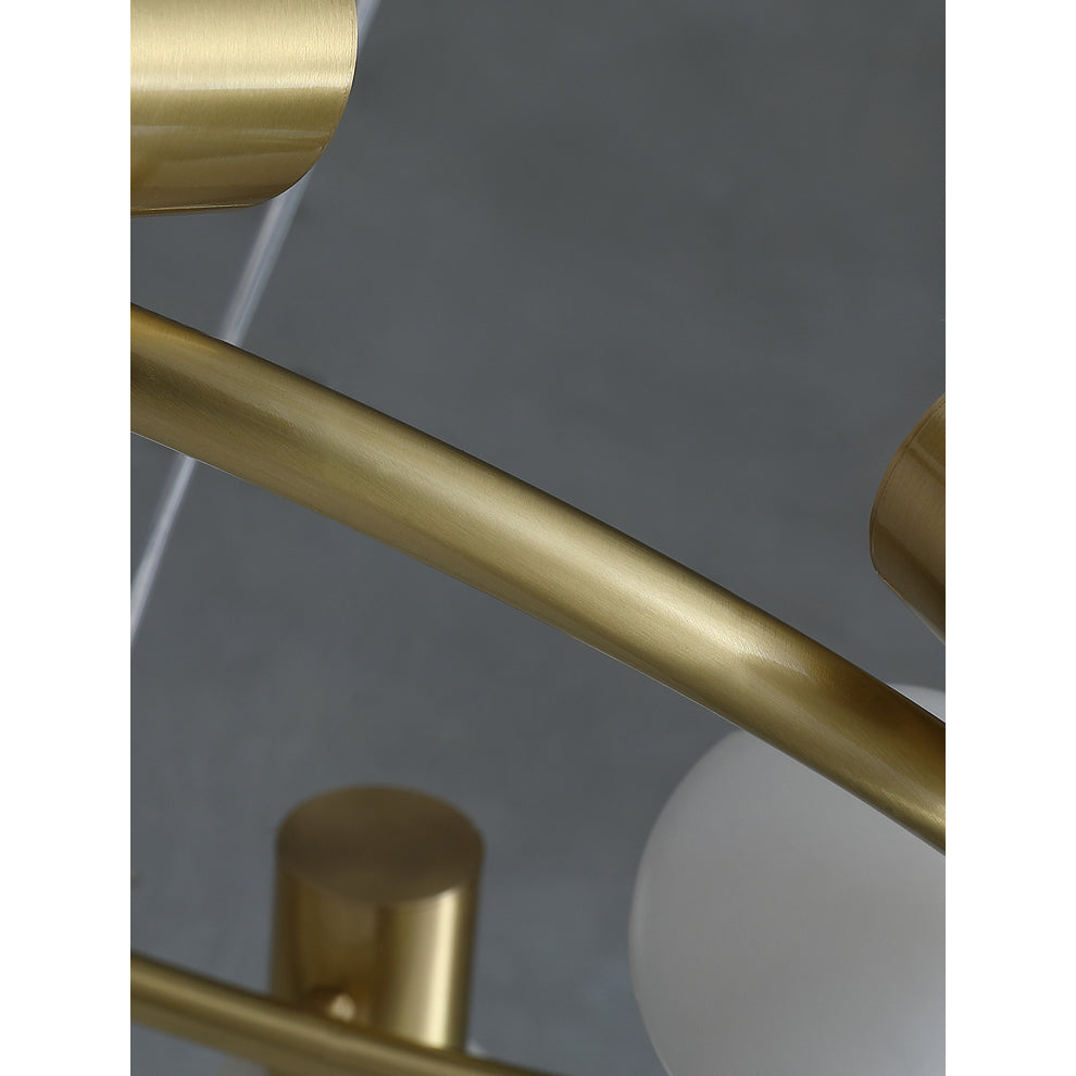 Macro detail of the brushed brass ring and the socket cylinders on the Clérachic Alabaster Globe Ring Chandelier.