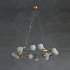 The full Clérachic Alabaster Globe Ring Chandelier suspended on three fine cables, stone globes unlit against grey plaster.