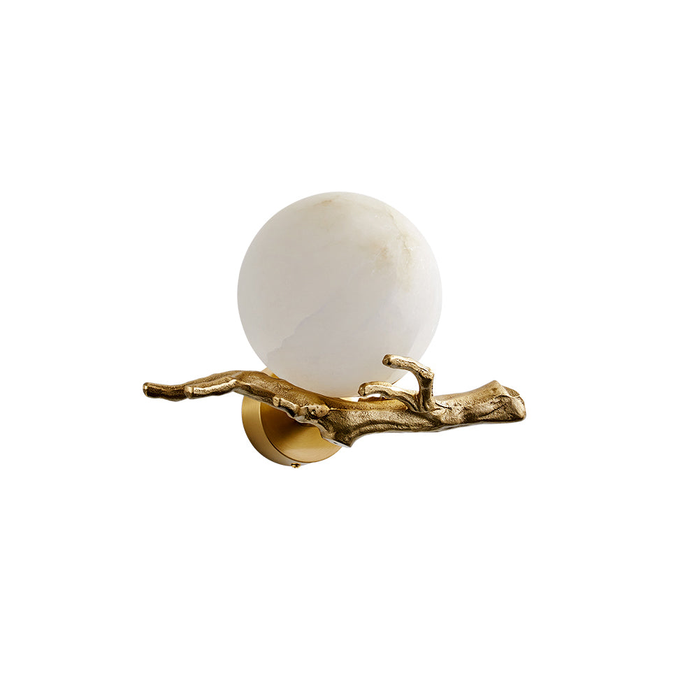 Clérachic Alabaster Globe Wall Sconce unlit on a white studio ground, its pale stone ball resting in the cast brass twig arm.