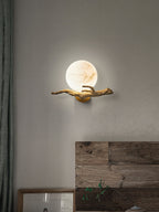 Clérachic Alabaster Globe Wall Sconce above a reclaimed timber headboard, the lit globe reading like a full moon on rough plaster.