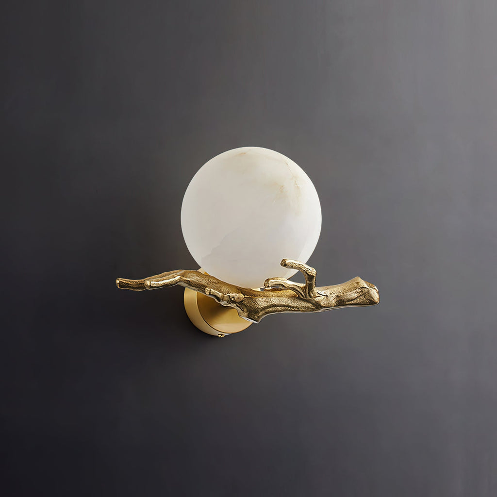 Clérachic Alabaster Globe Wall Sconce unlit on a dark grey ground, the polished brass branch running the full width of the piece.