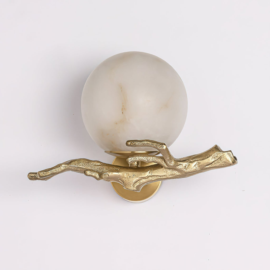 Clérachic Alabaster Globe Wall Sconce on a pale ground, the cast arm's bark ridges and branchlets picked out in polished brass.