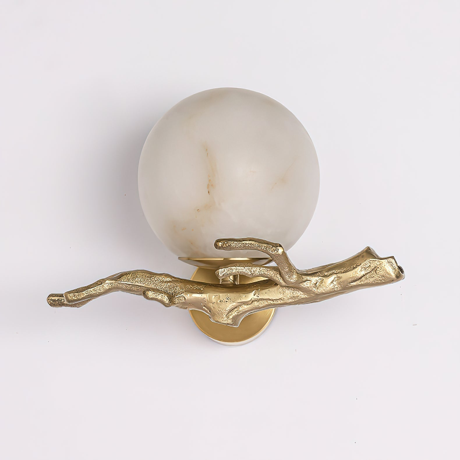 Clérachic Alabaster Globe Wall Sconce on a pale ground, the cast arm's bark ridges and branchlets picked out in polished brass.