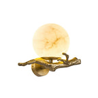 Clérachic Alabaster Globe Wall Sconce on a plain white ground, warm stone ball seated on the round backplate and cast branch.