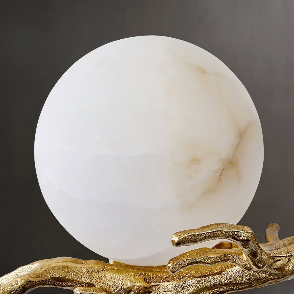 Close view of the Clérachic Alabaster Globe Wall Sconce's stone ball, its natural veining and cloudy grain visible unlit.