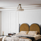 Wide room view with a small Clérachic alabaster ceiling light high above a bed with an arched mustard headboard and white wall panelling.