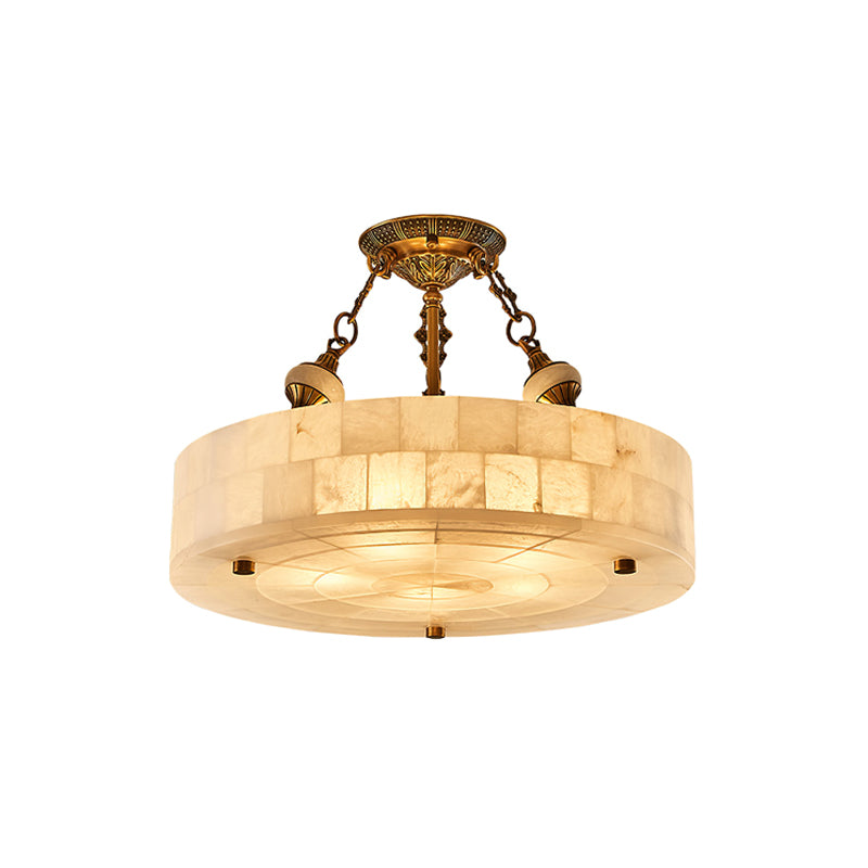 Clérachic alabaster ceiling light with a wider drum and brass canopy, shown lit and cut out on a plain white backdrop.